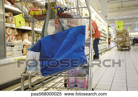 Reusable shopping bag hanging from shopping cart in supermarket View Large Photo Image Stock Photography - Reusable shopping bag hanging from shopping cart in supermarket. Fotosearch