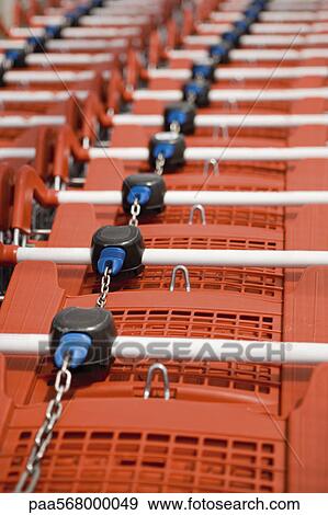 Shopping carts in row, close-up View Large Photo Image Stock Photo - Shopping carts in row, close-up. Fotosearch