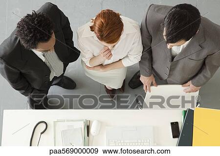 Stock Photo - Business associates collaborating on project. Fotosearch