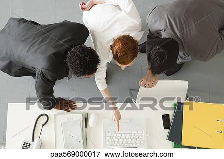 Business associates collaborating on project View Large Photo Image Stock Photo - Business associates collaborating on project. Fotosearch