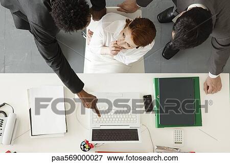 Stock Photo - Business associates collaborating on project. Fotosearch