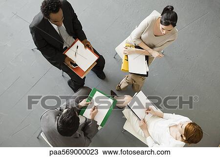 Stock Image - Business people having team-meeting. Fotosearch