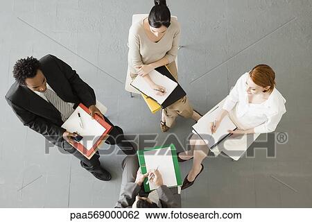 Stock Image - Business people having team-meeting. Fotosearch