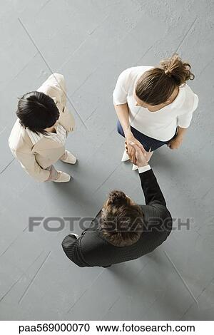 Business people shaking hands, overhead view View Large Photo Image Stock Image - Business people shaking hands, overhead view. Fotosearch