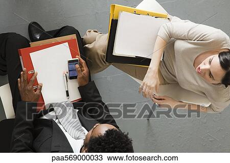Businesswoman meeting with associate, overhead view View Large Photo Image Stock Image - Businesswoman meeting with associate, overhead view. Fotosearch