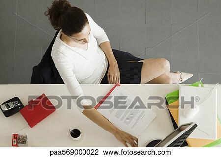 Businesswoman working at desk View Large Photo Image Stock Image - Businesswoman working at desk. Fotosearch