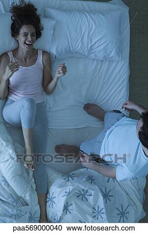 Couple having fun on bed View Large Photo Image Stock Image - Couple having fun on bed. Fotosearch