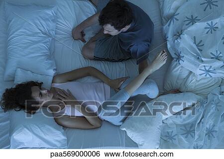 Couple having serious conversation in bed View Large Photo Image Stock Photograph - Couple having serious conversation in bed. Fotosearch
