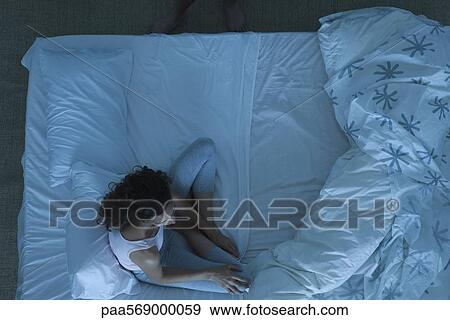 Couple in conflict, woman sitting on bed looking away View Large Photo Image Stock Photo - Couple in conflict, woman sitting on bed looking away. Fotosearch