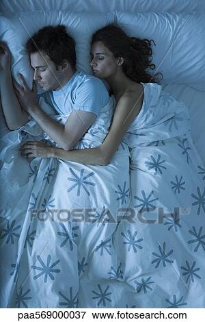 Couple sleeping, woman embracing man View Large Photo Image Stock Photo - Couple sleeping, woman embracing man. Fotosearch