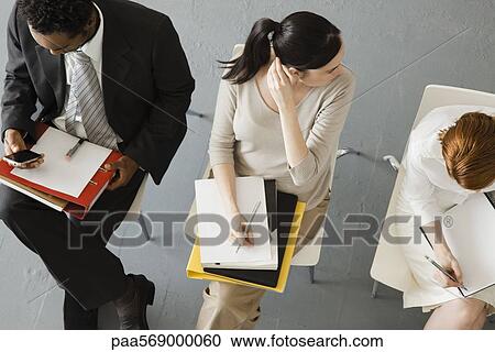 Professionals waiting for meeting to begin View Large Photo Image Stock Image - Professionals waiting for meeting to begin. Fotosearch