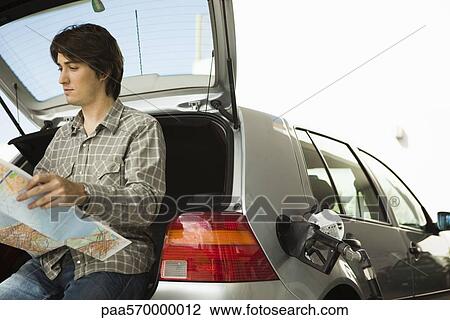 At gas station refueling, checking map View Large Photo Image Stock Image - At gas station refueling, checking map. Fotosearch