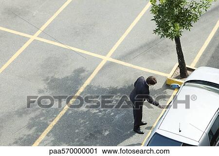 Businessman unlocking car door View Large Photo Image Stock Image - Businessman unlocking car door. Fotosearch
