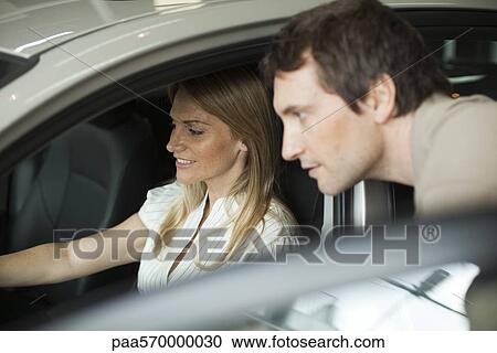 Couple checking out new car View Large Photo Image Stock Image - Couple checking out new car. Fotosearch