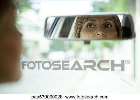Driver checking rear view mirror View Large Photo Image Stock Photo - Driver checking rear view mirror. Fotosearch