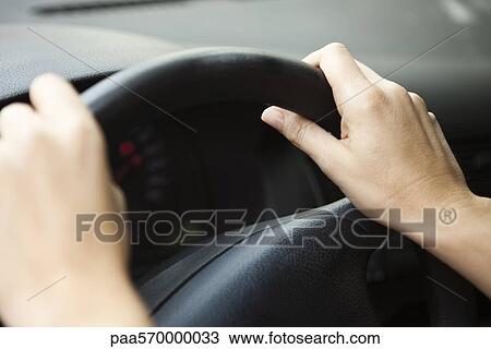 Driver with hands on the steering wheel View Large Photo Image Stock Image - Driver with hands on the steering wheel. Fotosearch