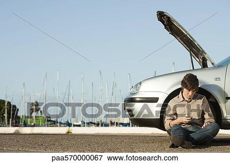Man having car trouble on side of road View Large Photo Image Stock Photo - Man having car trouble on side of road. Fotosearch