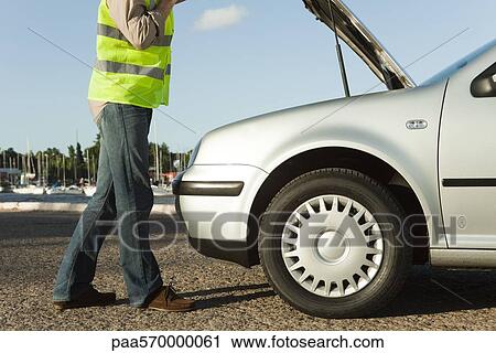 Mechanic evaluating car breakdown on side of road View Large Photo Image Stock Image - Mechanic evaluating car breakdown on side of road. Fotosearch