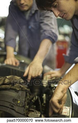 Mechanics repairing car engine View Large Photo Image Stock Image - Mechanics repairing car engine. Fotosearch