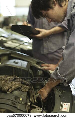Mechanics repairing car engine View Large Photo Image Stock Image - Mechanics repairing car engine. Fotosearch