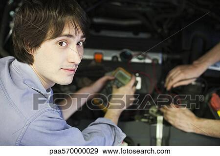 Mechanics repairing car engine View Large Photo Image Stock Photo - Mechanics repairing car engine. Fotosearch