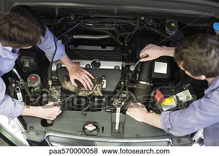 Mechanics reparing car engine View Large Photo Image Stock Photo - Mechanics reparing car engine. Fotosearch