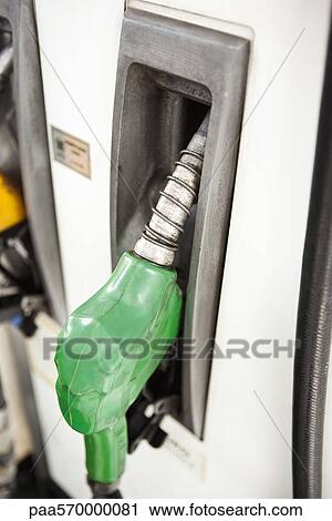 Stock Image - Nozzle in place on gas pump. Fotosearch