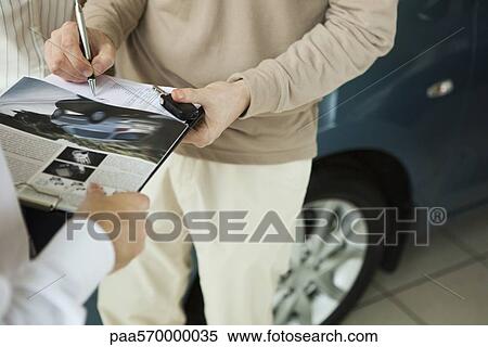 Signing document and accepting keys to car View Large Photo Image Stock Photography - Signing document and accepting keys to car. Fotosearch