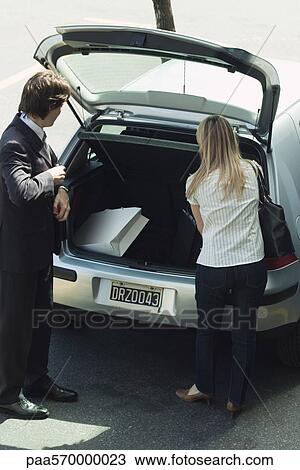 Stowing shopping bags in back of car View Large Photo Image Stock Image - Stowing shopping bags in back of car. Fotosearch
