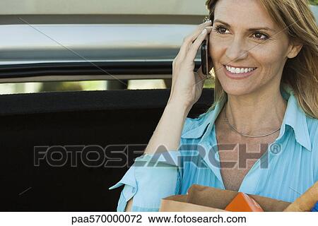 Woman using cell phone, portrait View Large Photo Image Stock Image - Woman using cell phone, portrait. Fotosearch