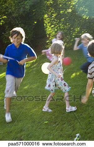 Children playing outdoors with balloons View Large Photo Image Stock Photograph - Children playing outdoors with balloons. Fotosearch