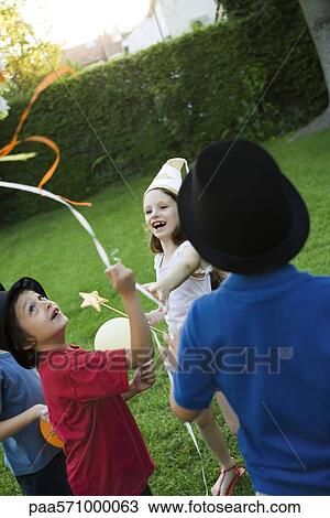 Children pulling streamers attached to pull string pinata View Large Photo Image Stock Image - Children pulling streamers attached to pull string pinata. Fotosearch