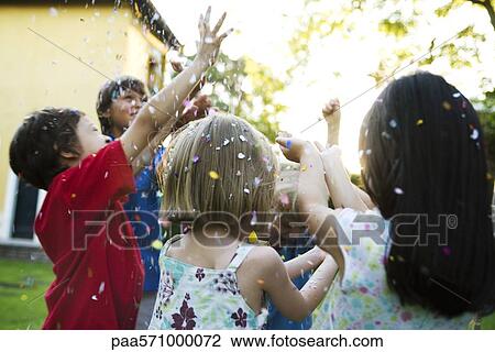 Children showered in falling confetti View Large Photo Image Stock Image - Children showered in falling confetti. Fotosearch