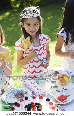 Picture - Girl in costume at outdoor birthday party. Fotosearch