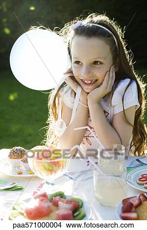 Girl smiling happily at birthday party View Large Photo Image Picture - Girl smiling happily at birthday party. Fotosearch