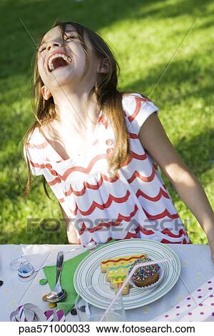 Girl with plate of sweets laughing View Large Photo Image Stock Image - Girl with plate of sweets laughing. Fotosearch
