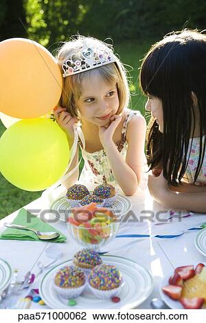Girls chatting at outdoor birthday party View Large Photo Image Stock Image - Girls chatting at outdoor birthday party. Fotosearch