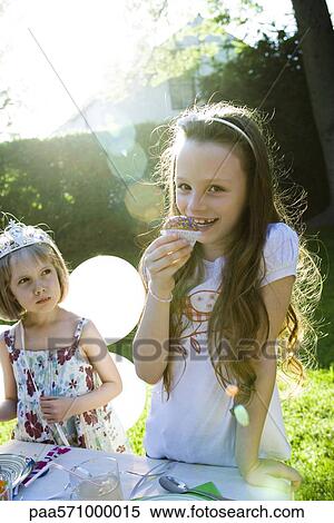 Girls eating sweets at birthday party View Large Photo Image Stock Photography - Girls eating sweets at birthday party. Fotosearch