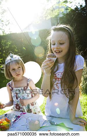 Girls eating sweets at birthday party View Large Photo Image Stock Photography - Girls eating sweets at birthday party. Fotosearch