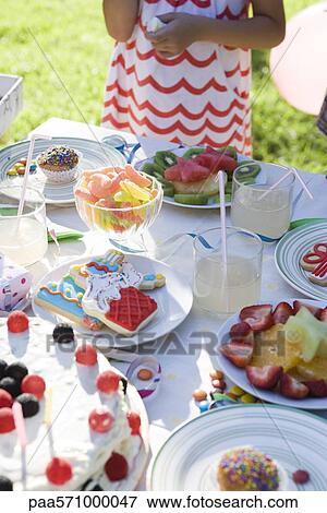 Sweets table at outdoor children's party View Large Photo Image Stock Photo - Sweets table at outdoor children's party. Fotosearch