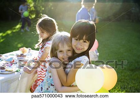Young friends embracing at outdoor party, portrait View Large Photo Image Stock Image - Young friends embracing at outdoor party, portrait. Fotosearch