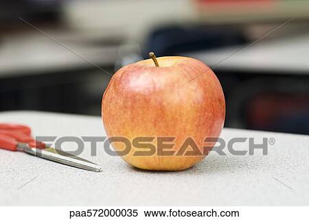 Apple on school desk View Large Photo Image Stock Photography - Apple on school desk. Fotosearch