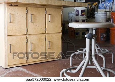 Cabinets and stools in workshop View Large Photo Image Stock Image - Cabinets and stools in workshop. Fotosearch