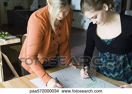 Female artists collaborating on drawing View Large Photo Image Picture - Female artists collaborating on drawing. Fotosearch