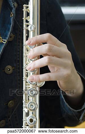 Holding flute View Large Photo Image Stock Photo - Holding flute. Fotosearch