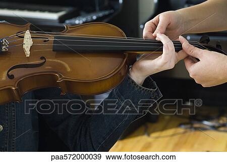 Learning to play the violin View Large Photo Image Stock Photo - Learning to play the violin. Fotosearch