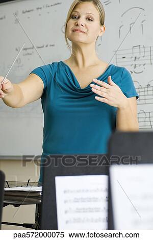 Music teacher conducting View Large Photo Image Stock Photography - Music teacher conducting. Fotosearch