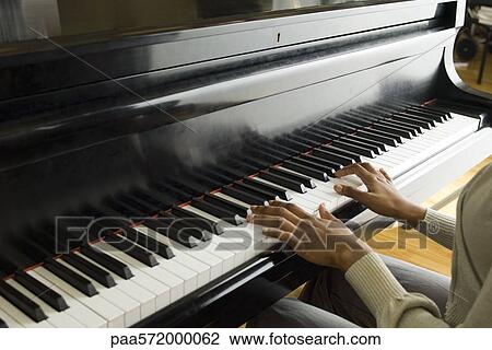 Stock Image - Pianist playing piano. Fotosearch