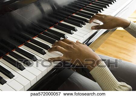 Playing piano View Large Photo Image Stock Photo - Playing piano. Fotosearch