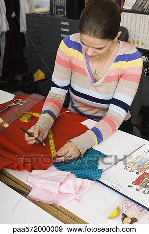 Preparing fabric for sewing project View Large Photo Image Stock Photo - Preparing fabric for sewing project. Fotosearch
